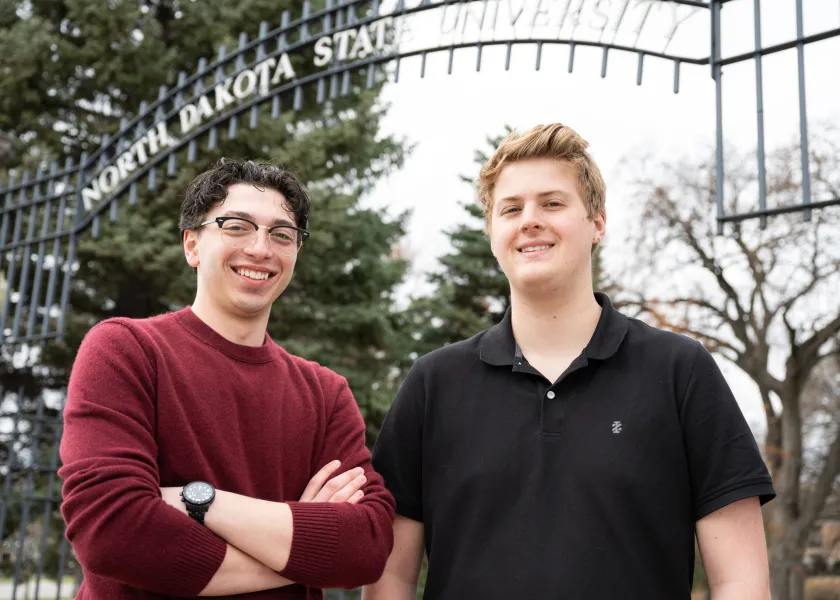 Nic Frello, student body president, and Caleb Jarvis, student body vice president standing in front of NDSU's main gates