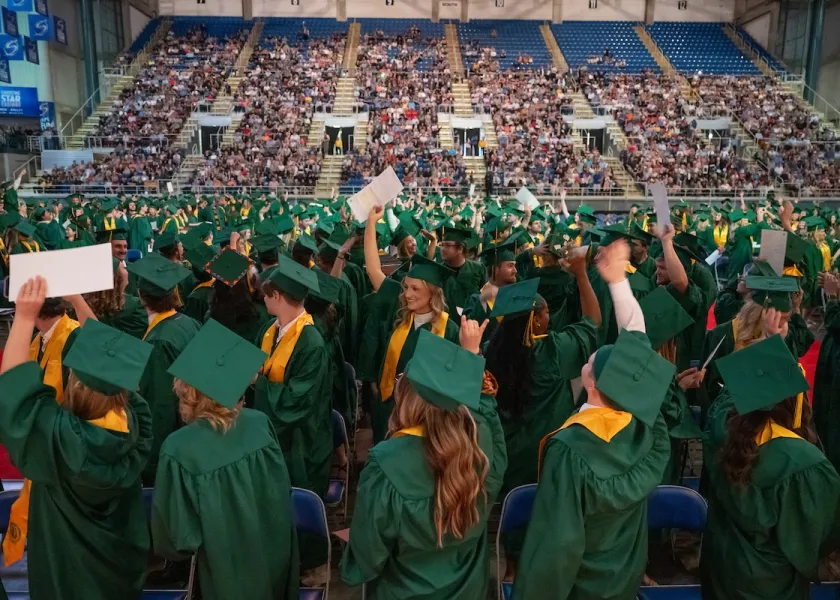 NDSU students in caps and gowns at the Fargodome