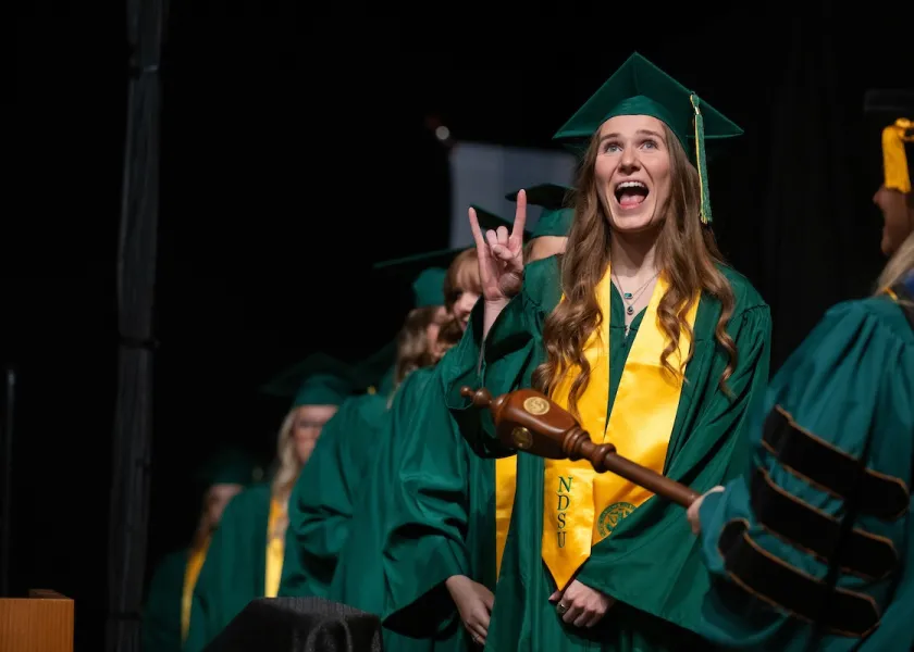 an NDSU graduate celebrating at commencement