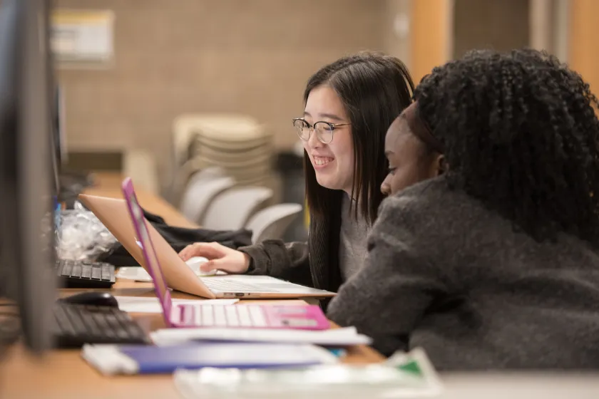 students looking at a laptop screen