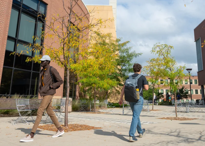 students walking between Memorial Union and A. Glenn Hill buildings
