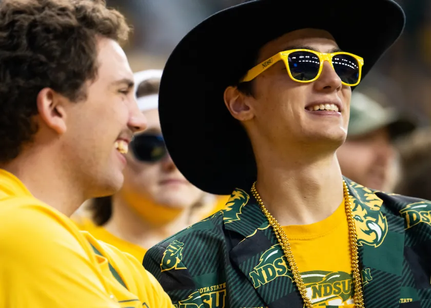 student at football dressed in green and yellow
