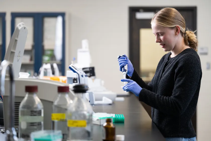 student working with sample in lab