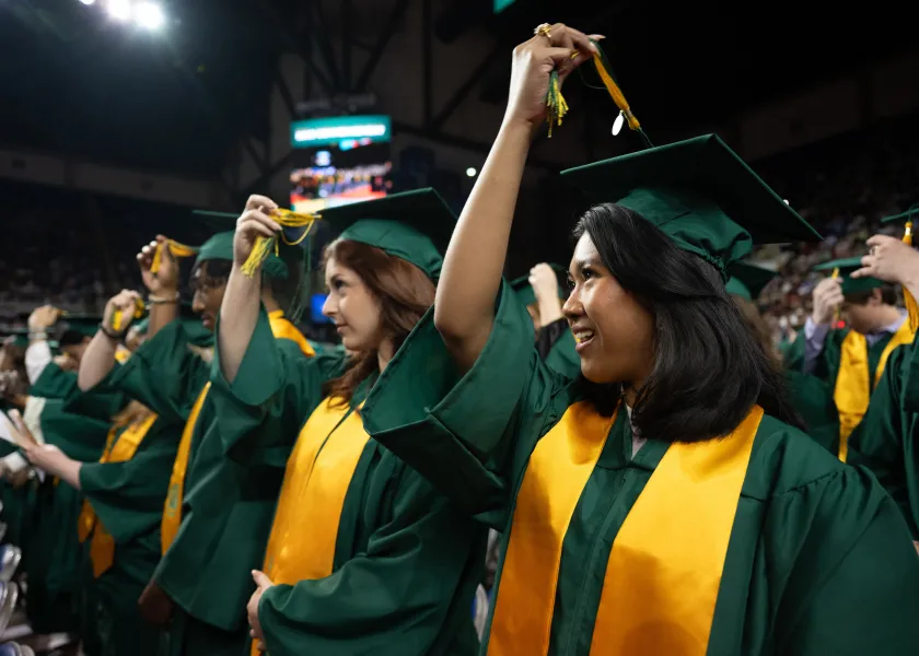 Graduating students turn the tassel on their caps during the spring 2025 commencement ceremony.