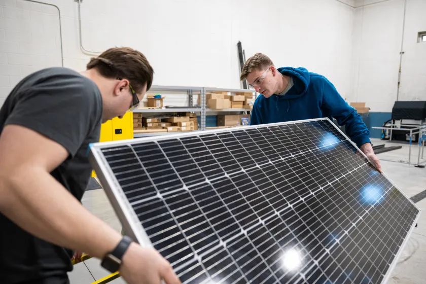 Engineering students working with a solar panel