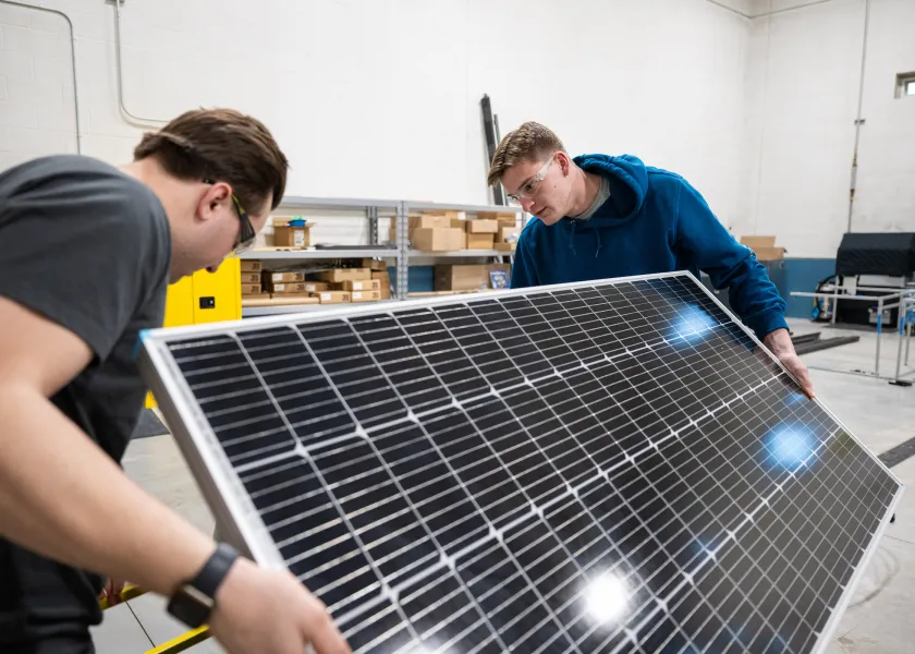 students working with a solar panel