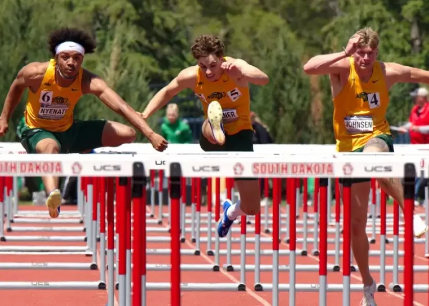 NDSU track and field athletes competing in a hurdles event.