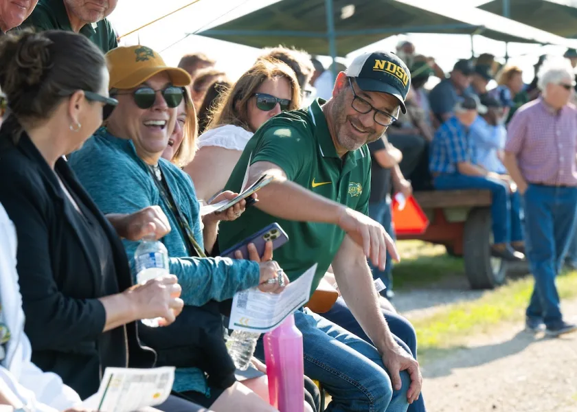 NDSU President David Cook talking with spectators at an NDSU Research Extension Center.