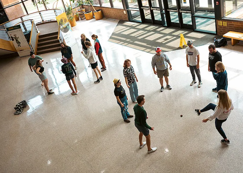 students playing a game in the Challey School of Music atrium