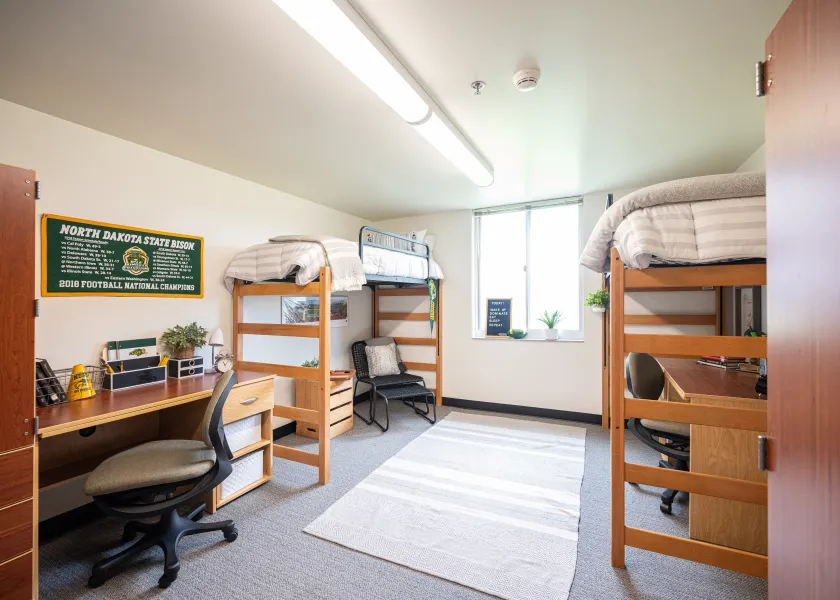 A newly renovated room in Pavek Hall with two lofted beds.