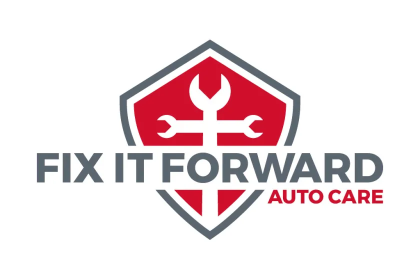 Logo for Fix It Forward Auto Care with a red shield and white wrenches in the shape of a cross