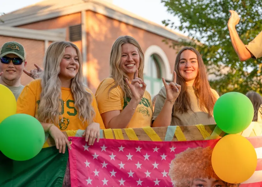 Students on a float during NDSU Homecoming.
