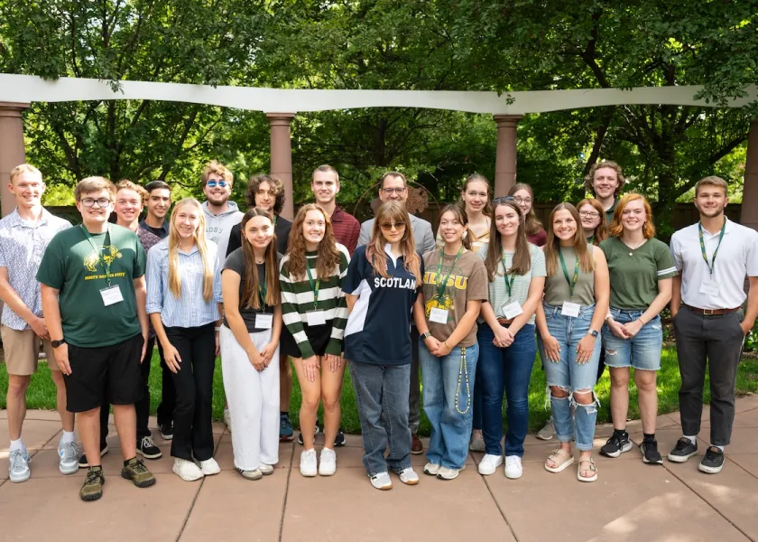 Scholars pose together.