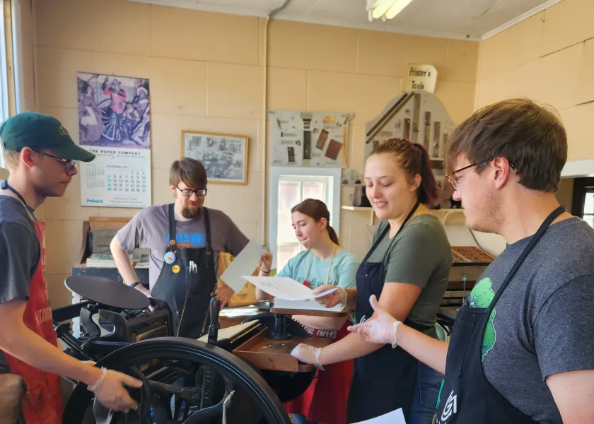 NDSU students in the Introduction to Publishing class use an antique printing press at Bonanzaville.