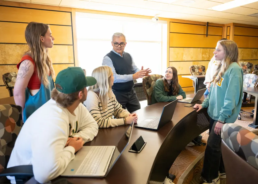 students interact with their professor during a business class