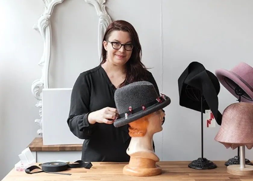 NDSU lecturer Anna Lee with her hat designs.