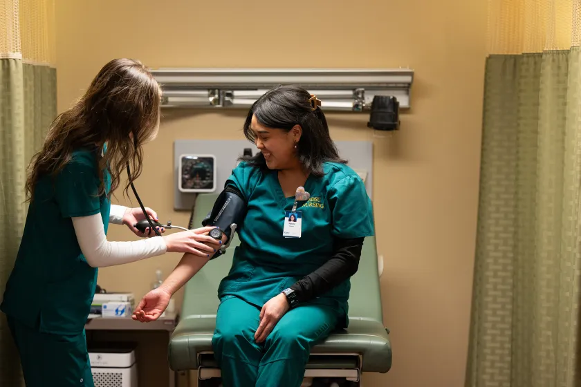 nursing students practicing with the blood pressure cuff