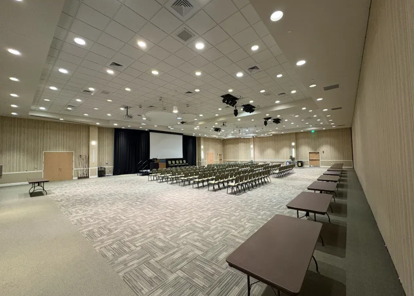 Ballroom A side with row seating and tables in the back