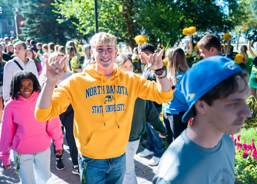 Students walk through the NDSU front gates.