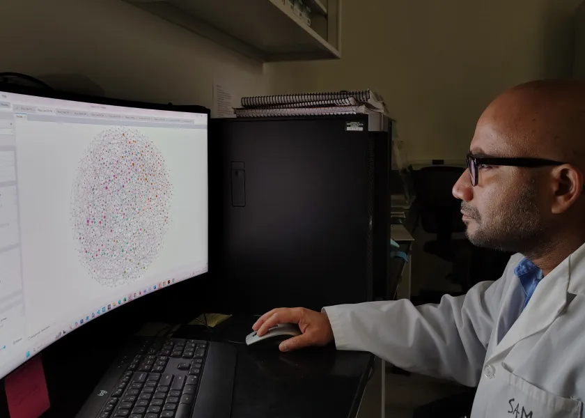 Samiran Banerjee, NDSU assistant professor of microbial ecology, sits in his lab while looking at a graph on a computer.