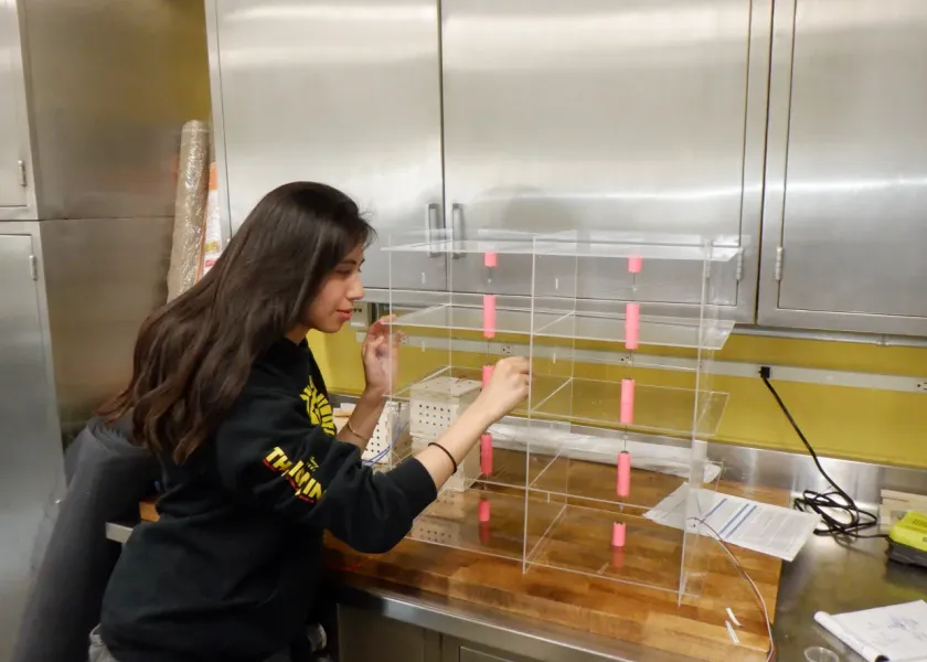 Lydia working with lab equipment.