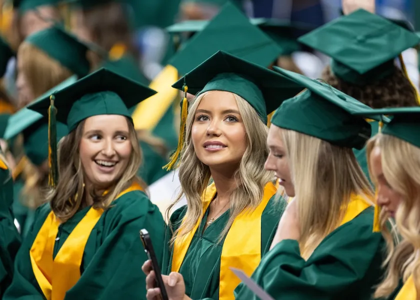 NDSU students in caps and gowns at commencement ceremony.