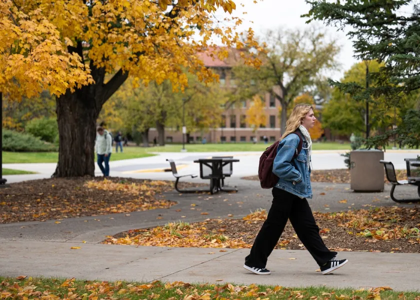 A student walks to class on NDSU's campus.