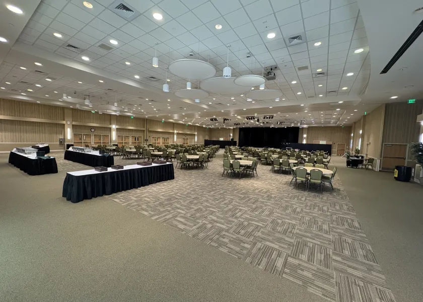 Oceti Sakowin Ballroom arranged with round tables for banquet