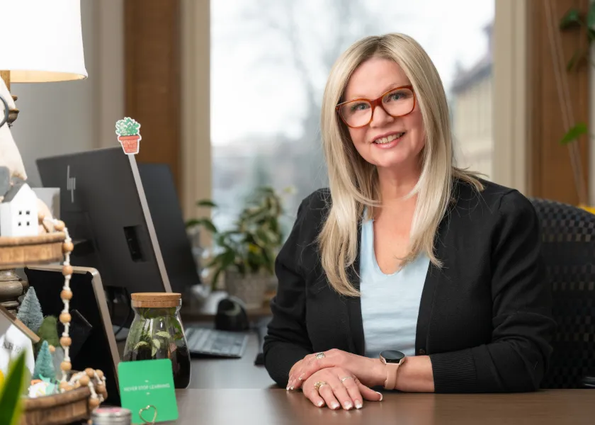 Angela Reinke, a lead student case manager at NDSU, poses for a photo at her desk in her office.