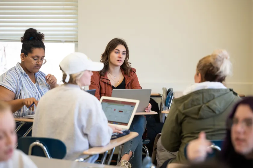 students having a discussion during writing class