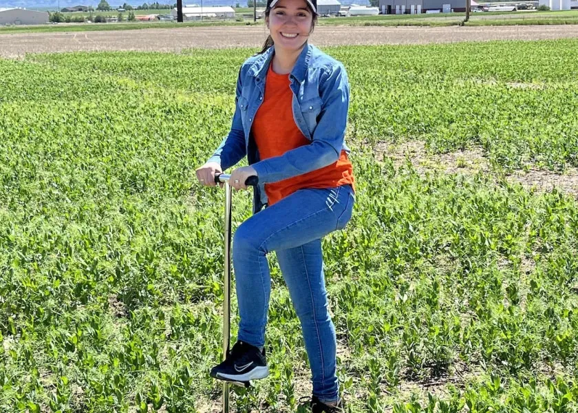 Eglantina Lopez Echartea, NDSU assistant professor of AES microbiological sciences standing in a field