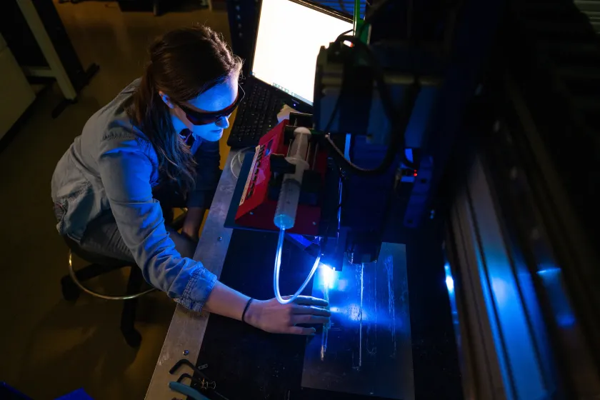 student working with a 3D printer