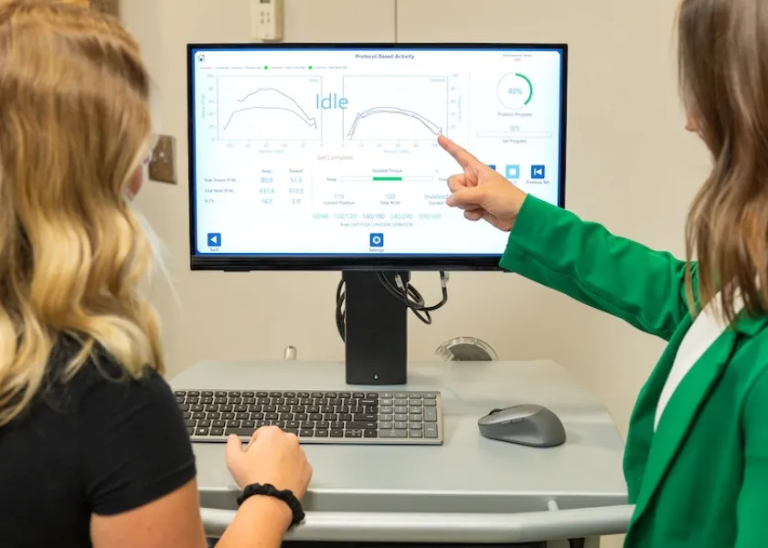 Two researchers in the NDSU Healthy Aging Lab looking at results on a computer screen.