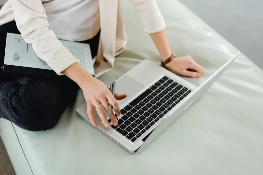 close up of student working on laptop