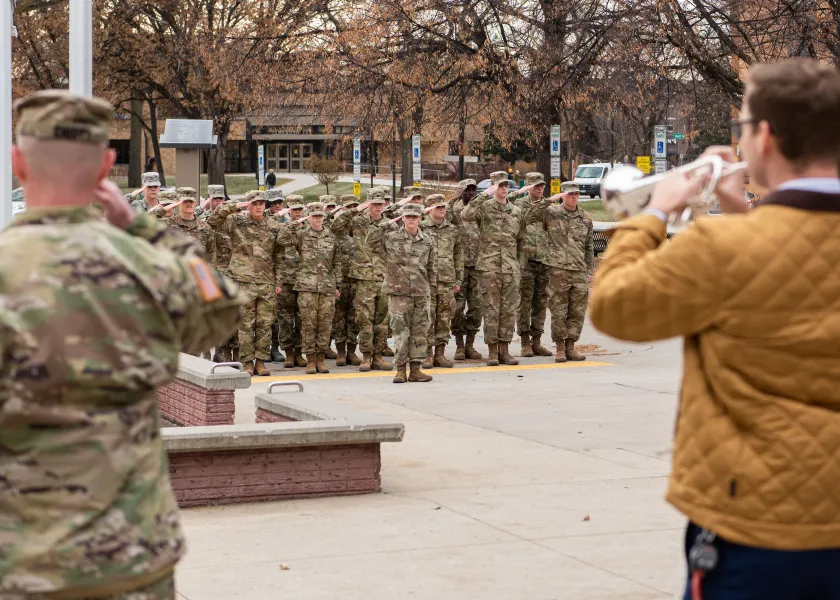 NDSU's annual Veterans Day program. Military members are standing at attention as Taps are played on the trumpet.