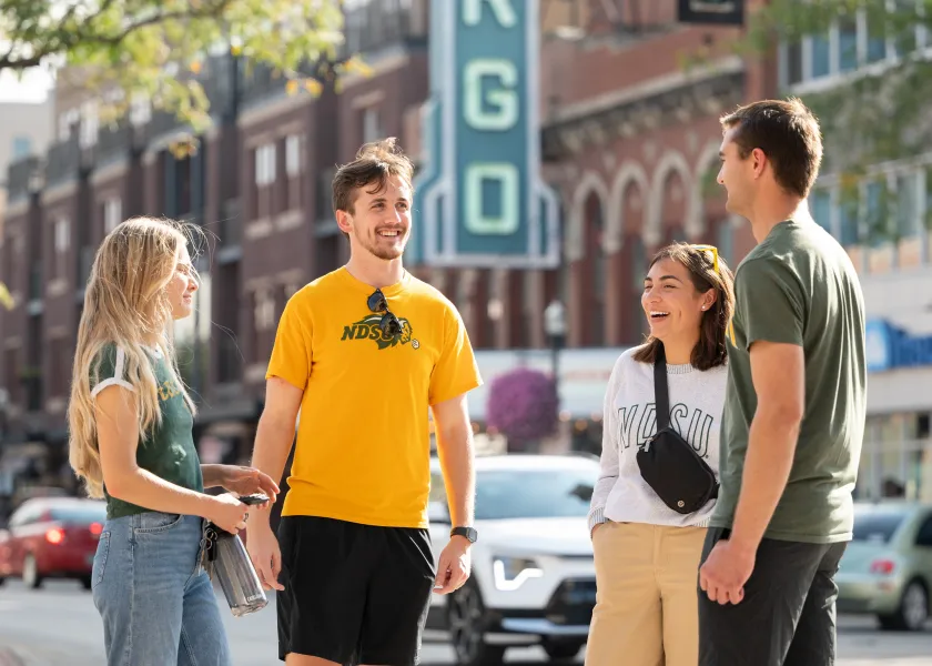 NDSU students stand in front of the Fargo Theatre in downtown Fargo.