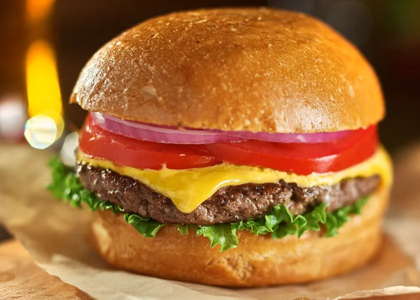 cheeseburger sitting on a cutting board