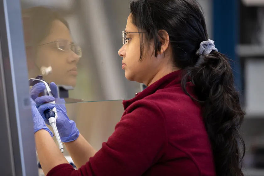 graduate Microbiology student works in a lab