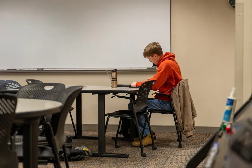 An NDSU student sits at a desk in the ACE Tutoring space.