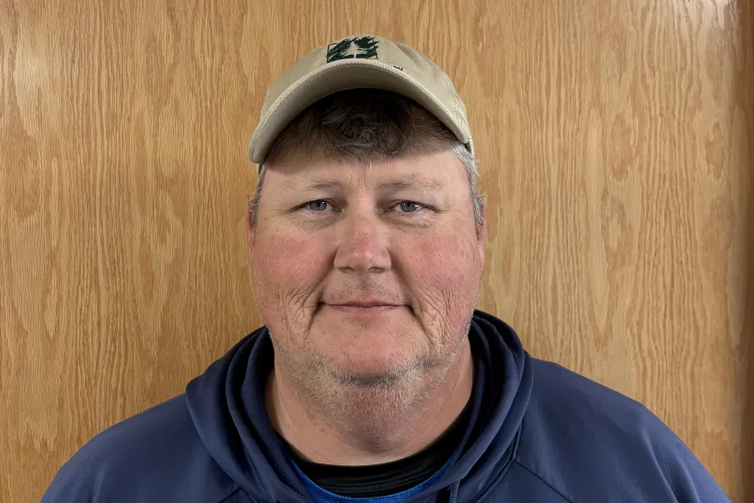 Headshot of a man in a hoodie and baseball cap