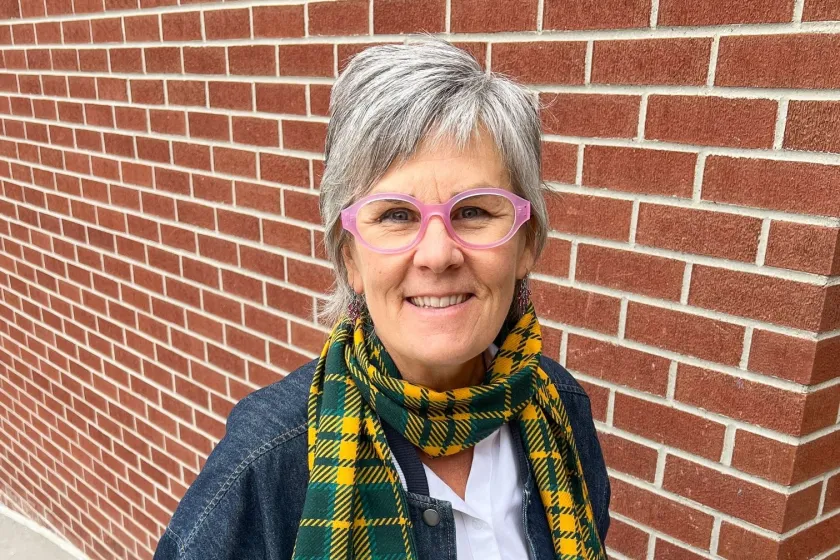 An NDSU employee wears a wool scarf, which is part of the Official NDSU Tartan collection.