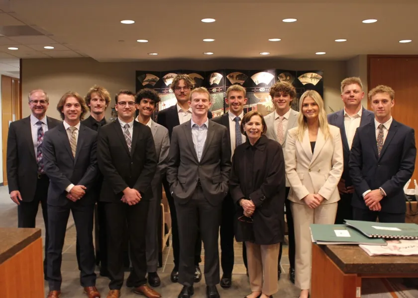 NDSU alum Marilyn Froelich poses for a photo with students in NDSU's Bison Fund.