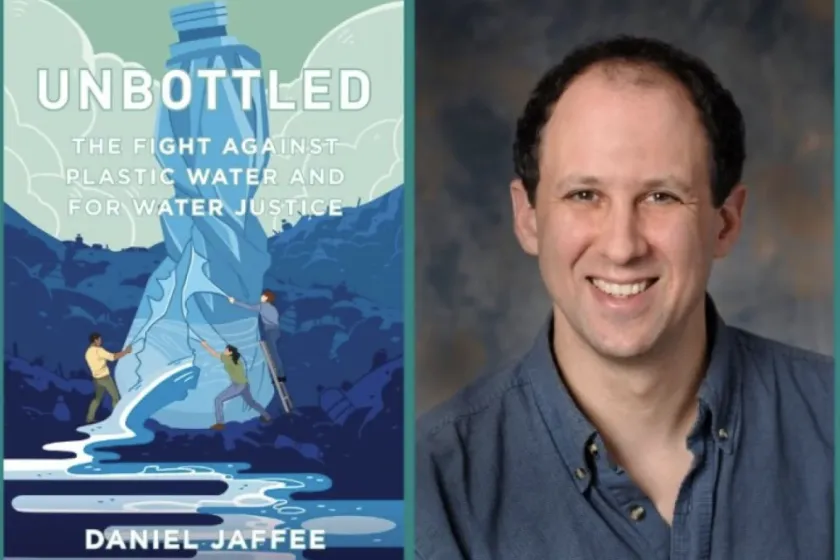 Man smiling at camera and book, Unbottled, pictured