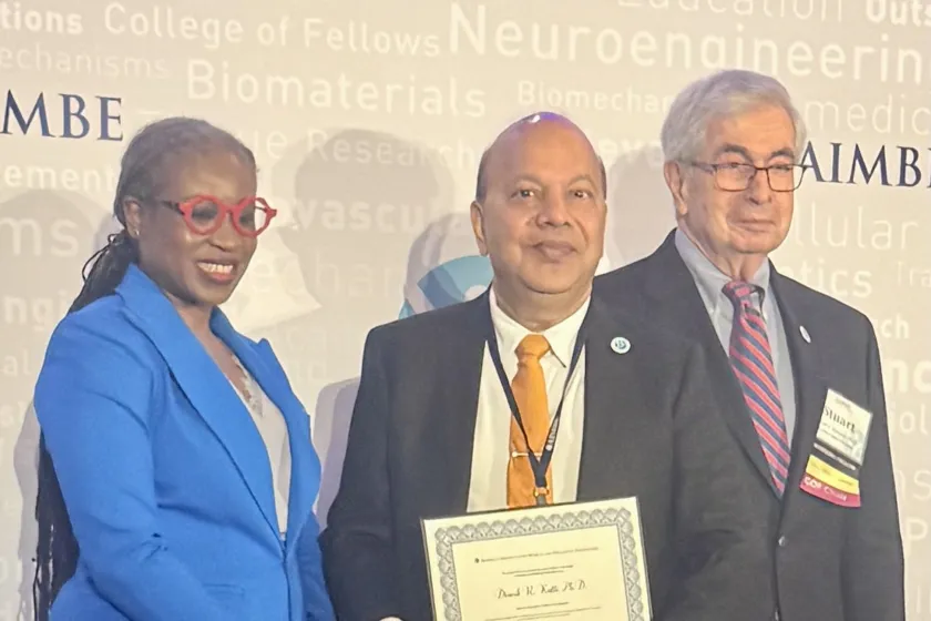 Dr. Dinesh Katti (center) holds his certificate after being inducted into the AIMBE College of Fellows.