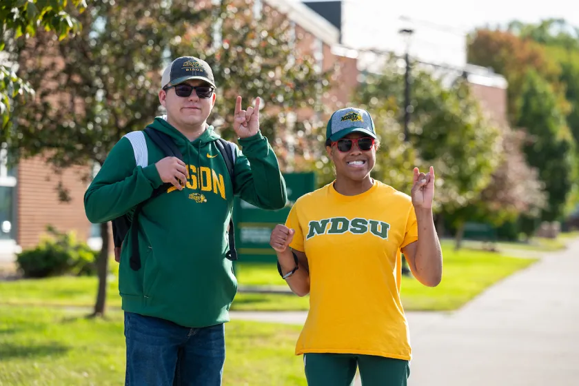 Transition and Access Program students, Charlie Kern (left) and Alexander Aikens (right) making the horns up Bison hand sign.
