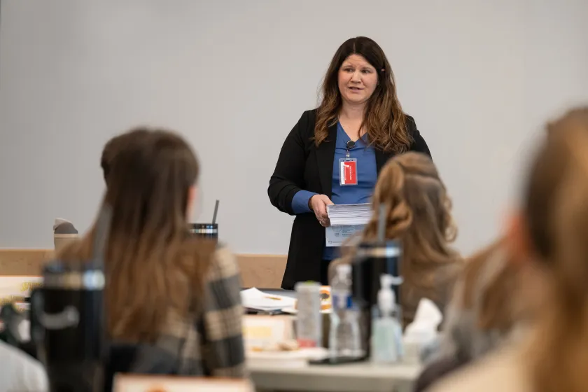 Faculty member in the Management degree program has discussion with students