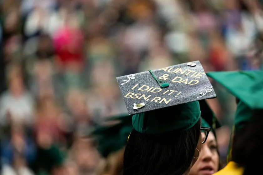 Graduation cap that reads Auntie and Dad I did it! BSN.RN