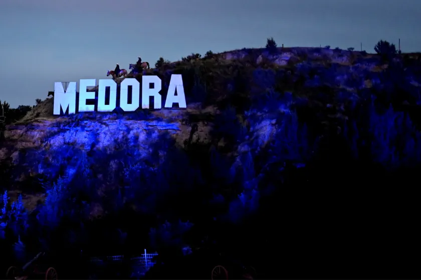 Medora sign illuminated at night during the annual Medora Musical in Medora, North Dakota.