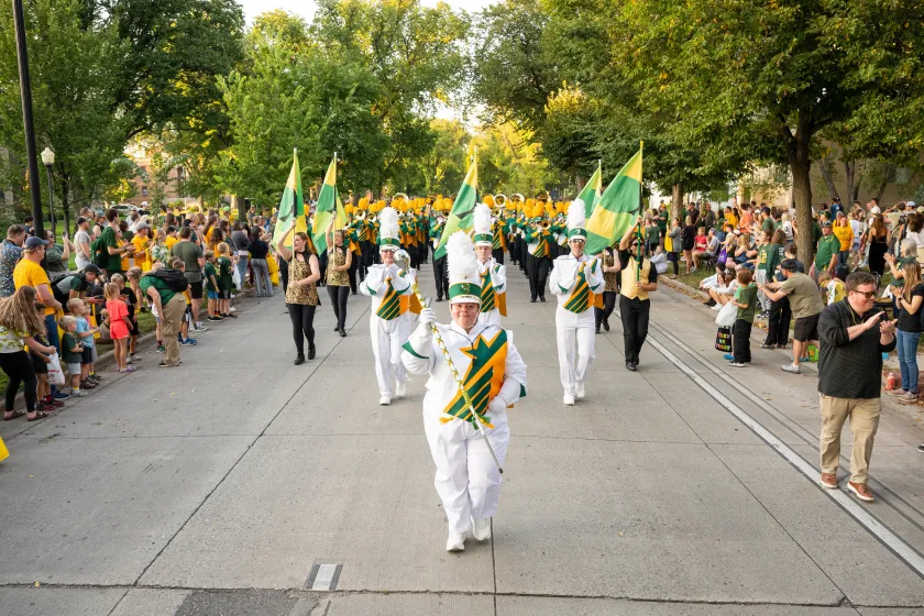 An NDSU drum majors walks down the street during a parade