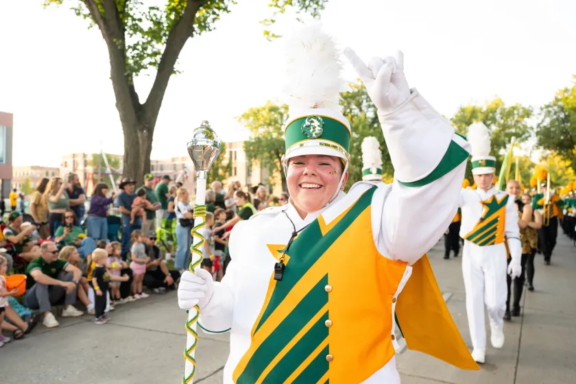 An NDSU Gold Star Marching Band drum major walks in the Homecoming parade